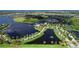 Expansive aerial view of community, lake, bridge, fountain, and lush landscaping at 1031 Signet, Apollo Beach, FL 33572