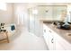 Elegant bathroom featuring a freestanding tub, glass-enclosed shower, and dual vanity with modern fixtures at 1031 Signet, Apollo Beach, FL 33572