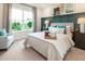 Comfortable bedroom with a queen-sized bed, upholstered headboard, and large window with a view at 1031 Signet, Apollo Beach, FL 33572