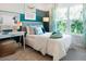 Bright ' bedroom with a color-blocked wall, desk, and a comfortable bed with patterned bedding at 1031 Signet, Apollo Beach, FL 33572