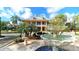 Charming two-story home with fountain feature and lush landscaping creating an inviting curb appeal at 1031 Signet, Apollo Beach, FL 33572
