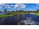Picturesque lake view with fountain, bridge, and lush landscaping creating a serene and inviting atmosphere at 1031 Signet, Apollo Beach, FL 33572