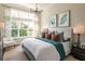 Inviting primary bedroom featuring a large window, decorative pillows, and stylish artwork above the bed at 1031 Signet, Apollo Beach, FL 33572