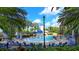 Community pool and water fountain surrounded by palm trees and lounge chairs at 1031 Signet, Apollo Beach, FL 33572