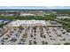 Overhead perspective of a retail space with ample parking, surrounded by various businesses and roadways at 2682 Edwin Ave, North Port, FL 34288