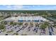 Aerial view of a commercial area featuring a large store with a big parking lot and nearby water views at 2682 Edwin Ave, North Port, FL 34288