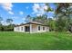 Lush backyard featuring a well-maintained lawn with a covered patio that enhances outdoor living at 2682 Edwin Ave, North Port, FL 34288