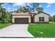 Charming single-Gathering home features a well-manicured lawn, two-car garage, and neutral color scheme at 2682 Edwin Ave, North Port, FL 34288