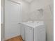 Efficient laundry area with modern washer and dryer, plus practical shelving for storage at 2682 Edwin Ave, North Port, FL 34288