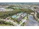 Aerial view of clubhouse, community pool, tennis courts, and surrounding wooded area at 29043 Picana Ln, Wesley Chapel, FL 33543