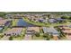 Expansive aerial view of a neighborhood with a lake and well-manicured lawns at 29043 Picana Ln, Wesley Chapel, FL 33543