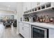 Stylish bar area with wine storage, mini-fridge, and modern finishes creates a space perfect for entertaining at 29043 Picana Ln, Wesley Chapel, FL 33543