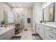 Bright bathroom with a soaking tub, a frameless glass shower, and double sinks with modern fixtures at 29043 Picana Ln, Wesley Chapel, FL 33543