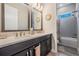 Bathroom with double vanity, quartz countertop, framed mirrors, and a shower/tub combination at 29043 Picana Ln, Wesley Chapel, FL 33543