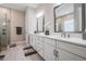 Contemporary bathroom with double sinks, a quartz countertop vanity, and a frameless glass shower at 29043 Picana Ln, Wesley Chapel, FL 33543