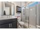 Bathroom featuring a modern vanity, toilet, and frameless glass shower with tiled walls at 29043 Picana Ln, Wesley Chapel, FL 33543