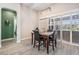 Cozy dining area with natural light, modern light fixture, and view of the backyard creates a welcoming atmosphere at 29043 Picana Ln, Wesley Chapel, FL 33543