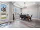 The dining room boasts a decorative light fixture and a gorgeous wood-tile floor at 29043 Picana Ln, Wesley Chapel, FL 33543