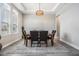 The dining room features a decorative light fixture and plenty of natural light at 29043 Picana Ln, Wesley Chapel, FL 33543