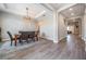An open-concept dining room with decorative light fixture and a gorgeous wood-tile floor at 29043 Picana Ln, Wesley Chapel, FL 33543