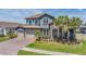 Beautiful two-story home featuring a stone facade, tile roof, three-car garage, and well-manicured landscaping at 29043 Picana Ln, Wesley Chapel, FL 33543