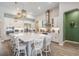 Spacious kitchen featuring an island with seating, modern lighting, and stainless appliances at 29043 Picana Ln, Wesley Chapel, FL 33543