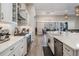 Well-lit kitchen with an island and white cabinets, open to the dining area at 29043 Picana Ln, Wesley Chapel, FL 33543