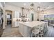 Modern kitchen with a large island, white cabinets, and stainless steel appliances at 29043 Picana Ln, Wesley Chapel, FL 33543