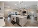 Open-concept kitchen features large island, stainless appliances, and seamless flow into living and dining areas at 29043 Picana Ln, Wesley Chapel, FL 33543