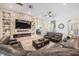 Inviting living room featuring a stone accent wall, fireplace, and comfortable seating, ideal for relaxation at 29043 Picana Ln, Wesley Chapel, FL 33543