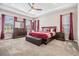Serene main bedroom suite with tray ceiling, ample natural light, and elegant furnishings creates relaxing retreat at 29043 Picana Ln, Wesley Chapel, FL 33543