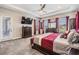 Comfortable main bedroom with tray ceiling, dresser, and outdoor access, offers a peaceful retreat at 29043 Picana Ln, Wesley Chapel, FL 33543