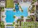 Aerial shot showcasing the community pool area, complete with a slide, lap lanes, and lush landscaping at 29043 Picana Ln, Wesley Chapel, FL 33543
