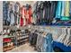 Organized walk-in closet offering ample storage with shelves and hanging racks for clothing and shoe collection at 29043 Picana Ln, Wesley Chapel, FL 33543