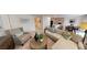 Inviting living room featuring modern furnishings, stylish decor, and an open layout connected to the kitchen at 28166 S Twin Lakes Dr, Punta Gorda, FL 33955