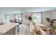 Bright living area adjacent to the dining room, featuring large windows and contemporary design elements for relaxed living at 28166 S Twin Lakes Dr, Punta Gorda, FL 33955