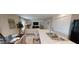Open-concept living area with modern kitchen island, dining area, and comfortable lounge seating at 28166 S Twin Lakes Dr, Punta Gorda, FL 33955