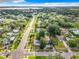 Expansive aerial view of a neighborhood with tree-lined streets leading to a scenic waterfront at 8231 Riverside Ne Dr, St Petersburg, FL 33702