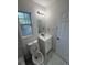 Neat bathroom featuring a white vanity, toilet, and tiled walls around the tub at 8231 Riverside Ne Dr, St Petersburg, FL 33702