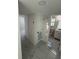 Hallway featuring white doors and modern, neutral-colored flooring, leading to bathroom at 8231 Riverside Ne Dr, St Petersburg, FL 33702