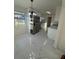 Bright kitchen with modern white cabinets, stainless steel appliances, and stylish marble flooring at 8231 Riverside Ne Dr, St Petersburg, FL 33702