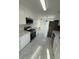 Modern kitchen featuring white cabinets, stainless steel appliances, and marble-look flooring at 8231 Riverside Ne Dr, St Petersburg, FL 33702