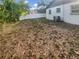 Side view of an empty backyard with a privacy fence and some trees at 1736 Taylor Lake Pl, Largo, FL 33778