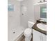 All-white tiled bathroom with a shower, toilet, and vanity at 1736 Taylor Lake Pl, Largo, FL 33778