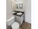 Clean bathroom featuring a toilet, vanity, and large mirror at 1736 Taylor Lake Pl, Largo, FL 33778