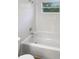 Bathroom with white tub/shower and tiled walls, offering a clean and bright space at 1736 Taylor Lake Pl, Largo, FL 33778