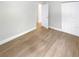 Comfortable bedroom with wood-look flooring, closet, and neutral wall color at 1736 Taylor Lake Pl, Largo, FL 33778