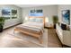 Sun-filled bedroom featuring hardwood floors, lots of light, and neutral decor at 1736 Taylor Lake Pl, Largo, FL 33778