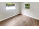 Bright bedroom featuring two windows offering plenty of natural light and wood-look floors at 1736 Taylor Lake Pl, Largo, FL 33778