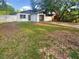 Charming single-story home with a white picket fence, a well manicured lawn and a driveway at 1736 Taylor Lake Pl, Largo, FL 33778